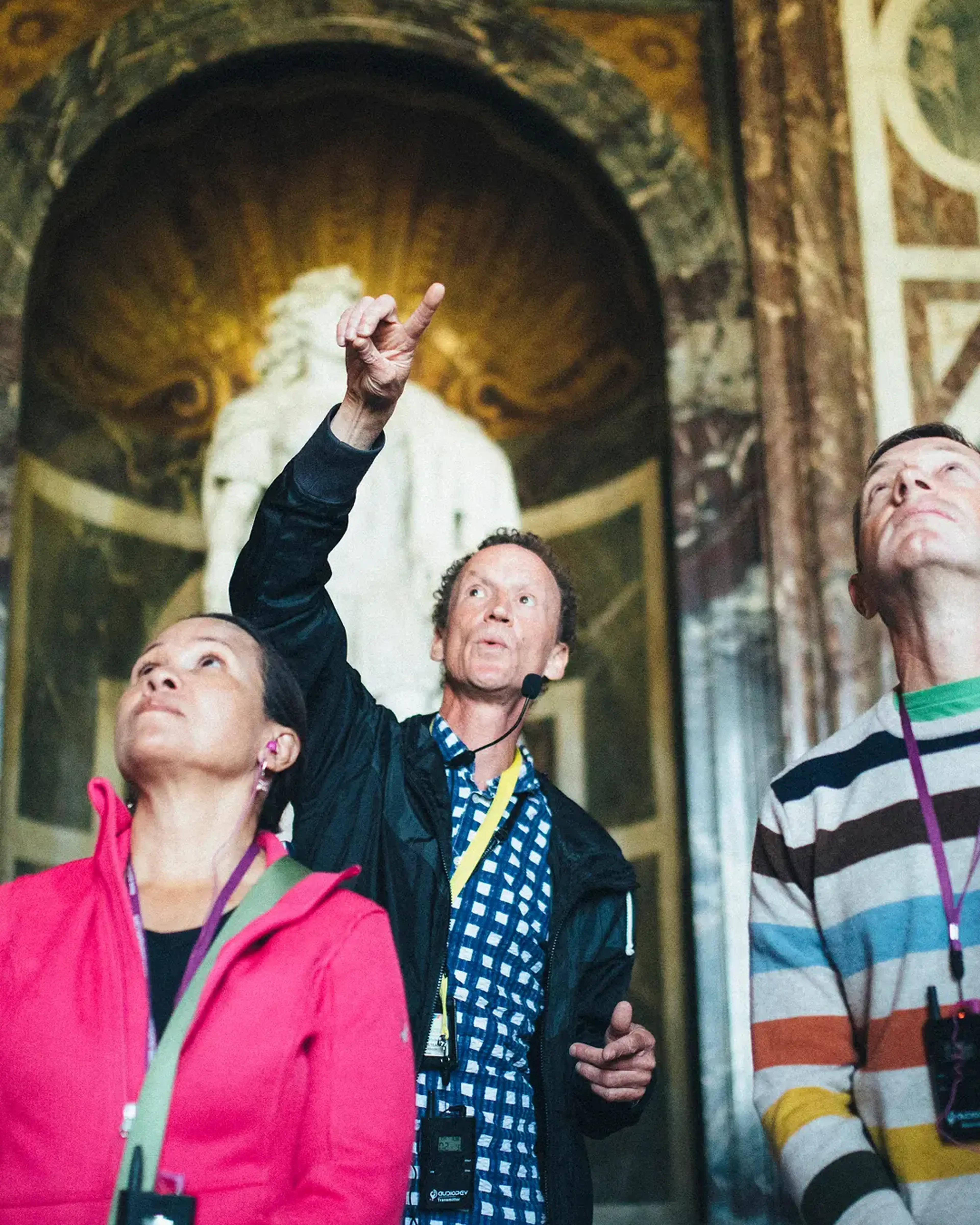 Tour director pointing and speaking with adult tour group