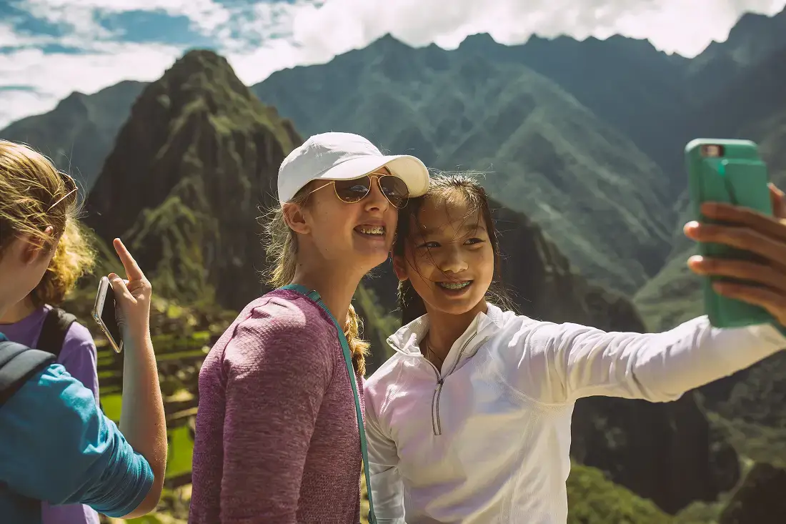 Two travelers taking a selfie at Machu Picchu