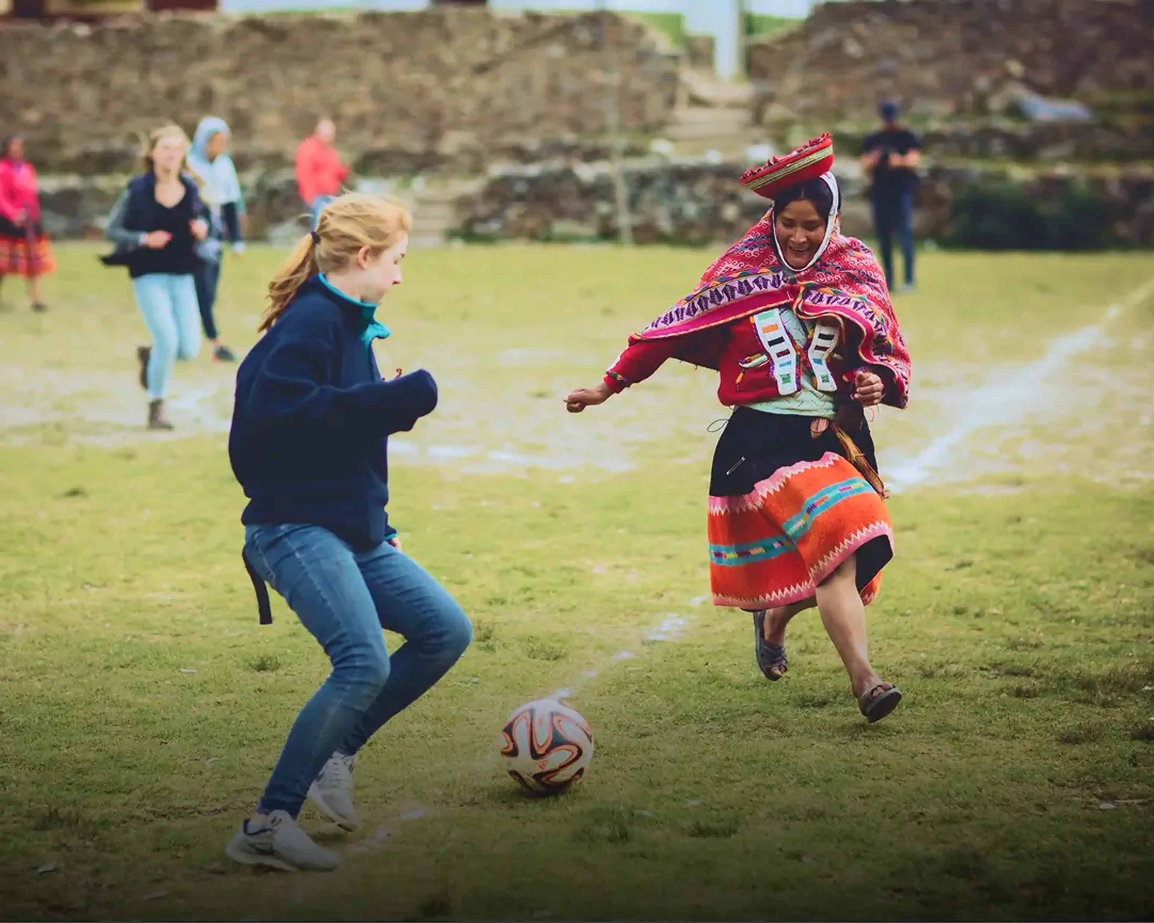 Student and local playing soccer in Peru