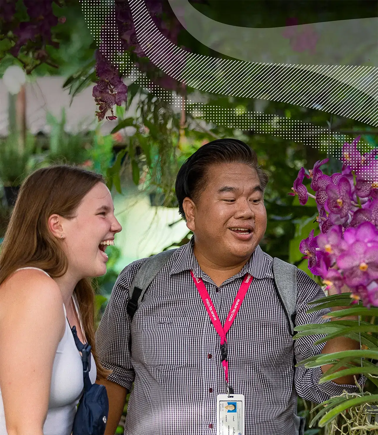 Tour Director showing vibrant purple flowers to traveler in Thailand