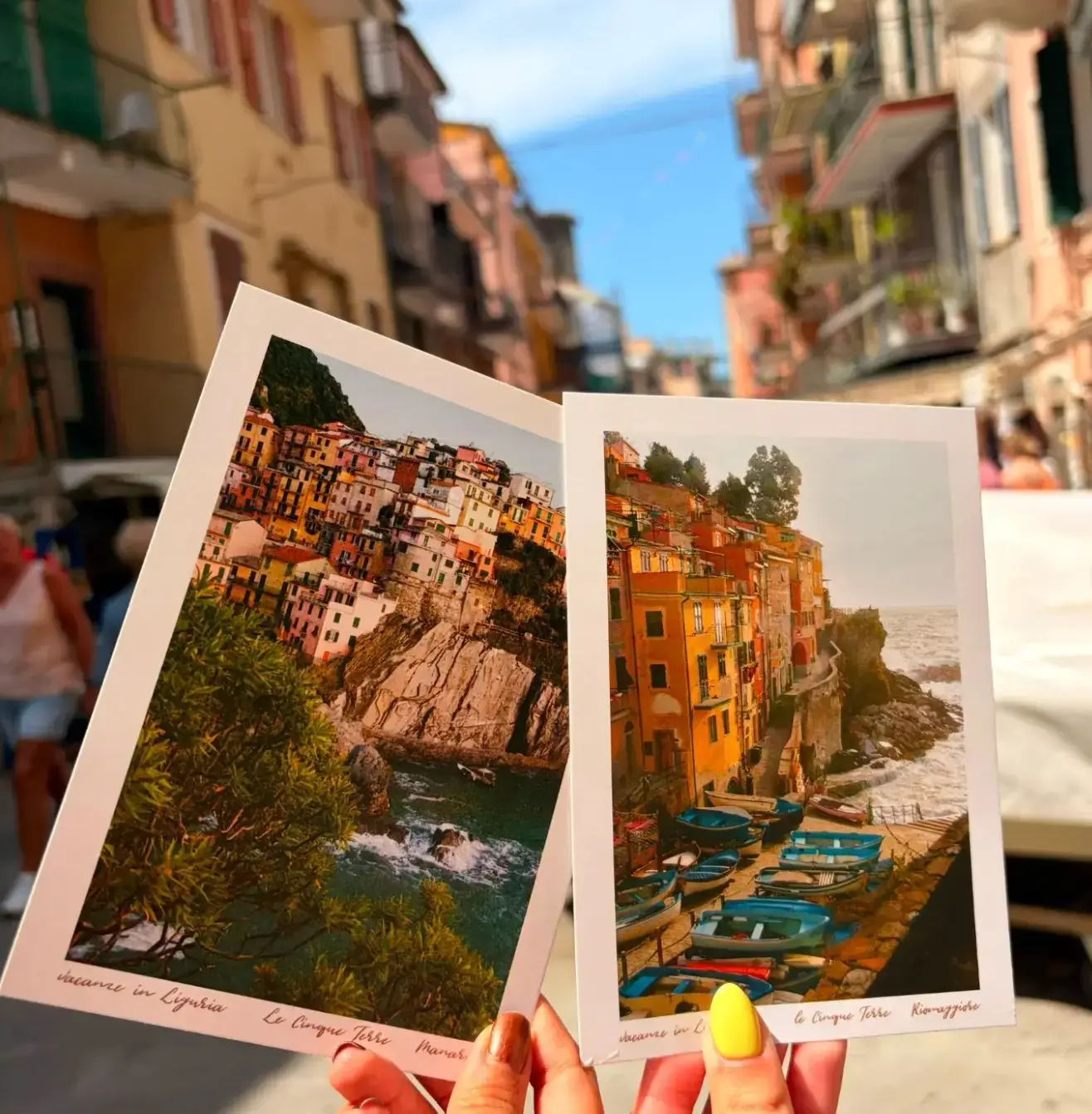 Travelers showing off post cards in Cinque Terre