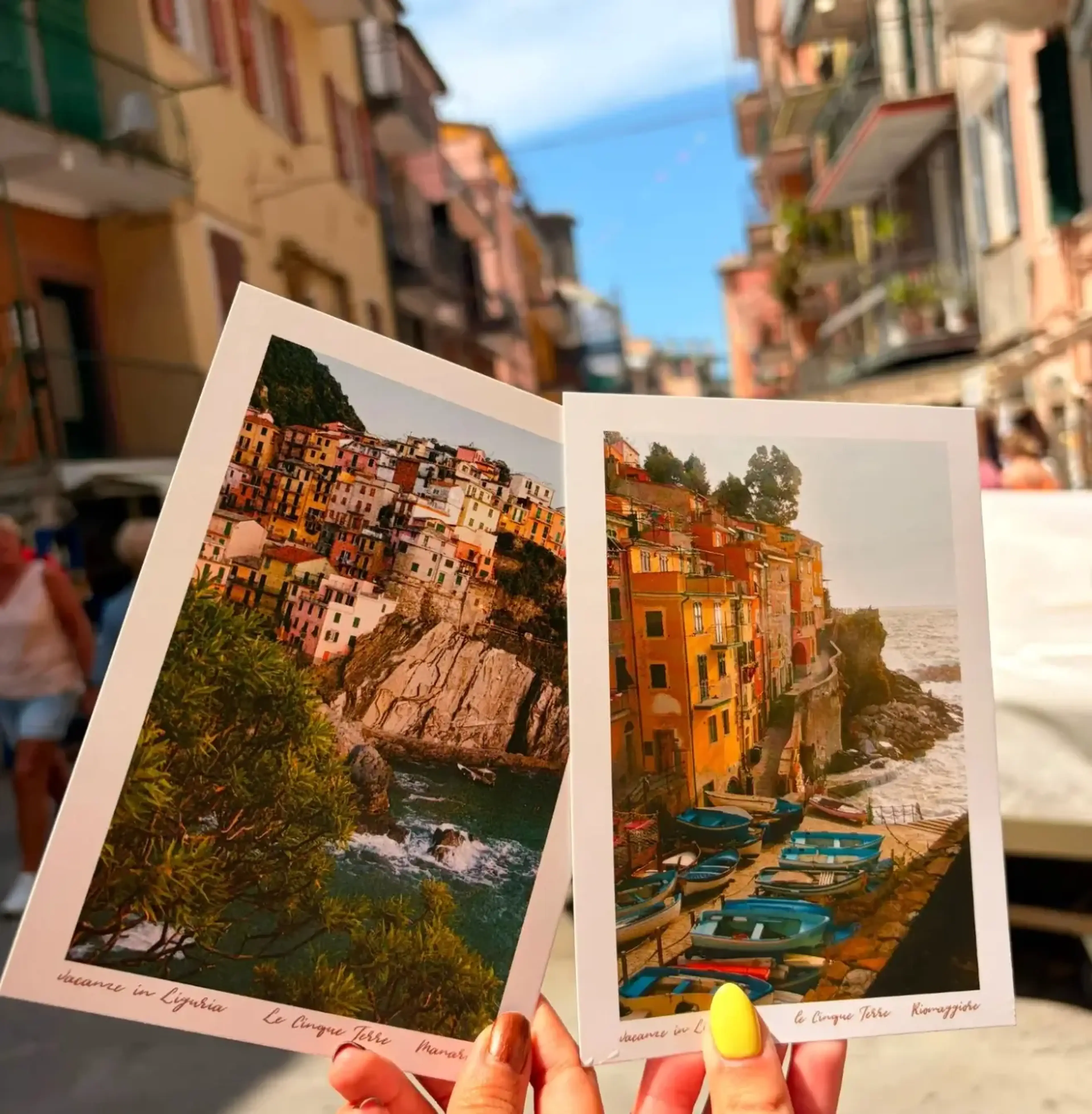 Travelers showing off post cards in Cinque Terre