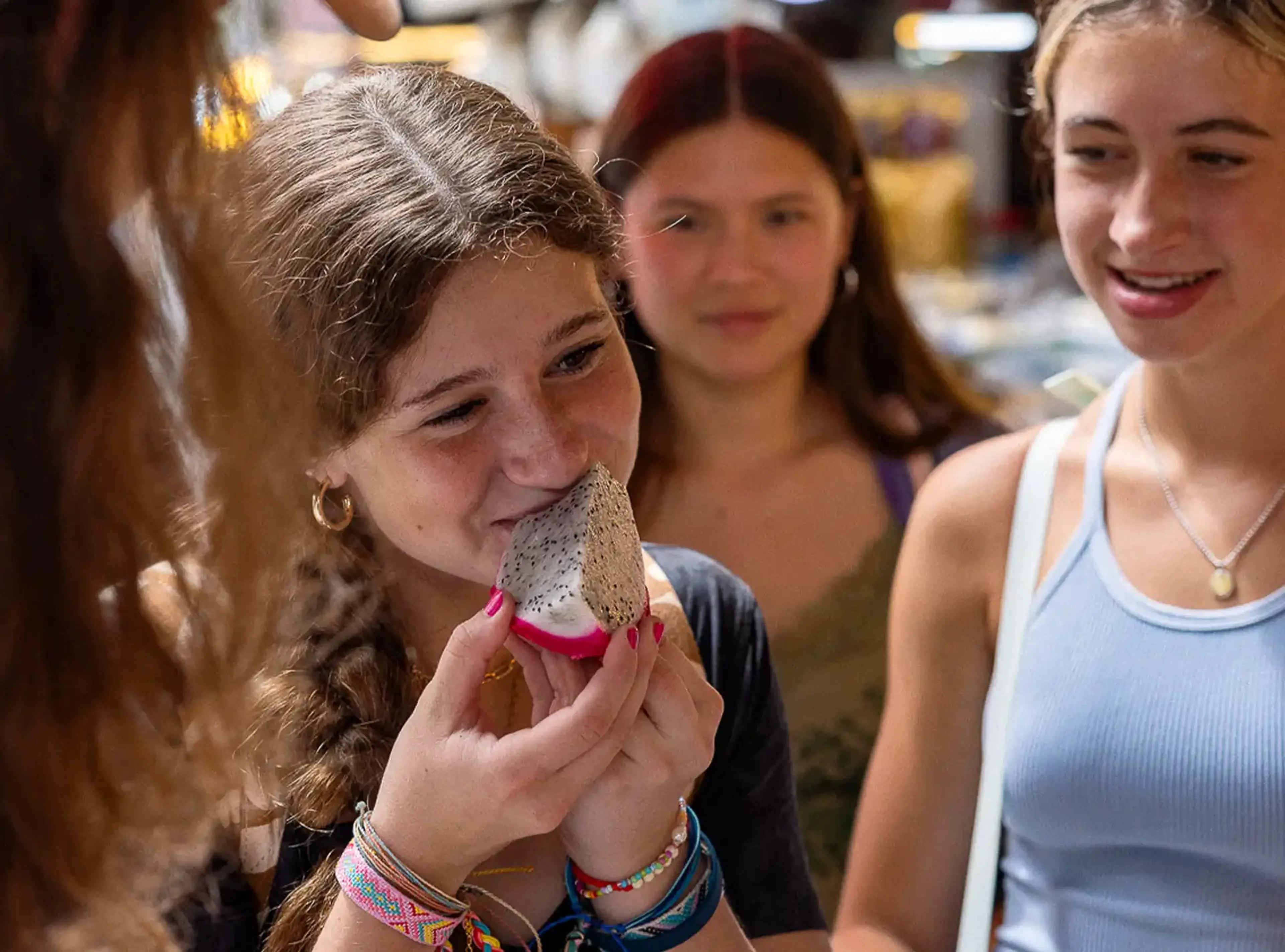 student trying new fruit with the help of EF student payment plans
