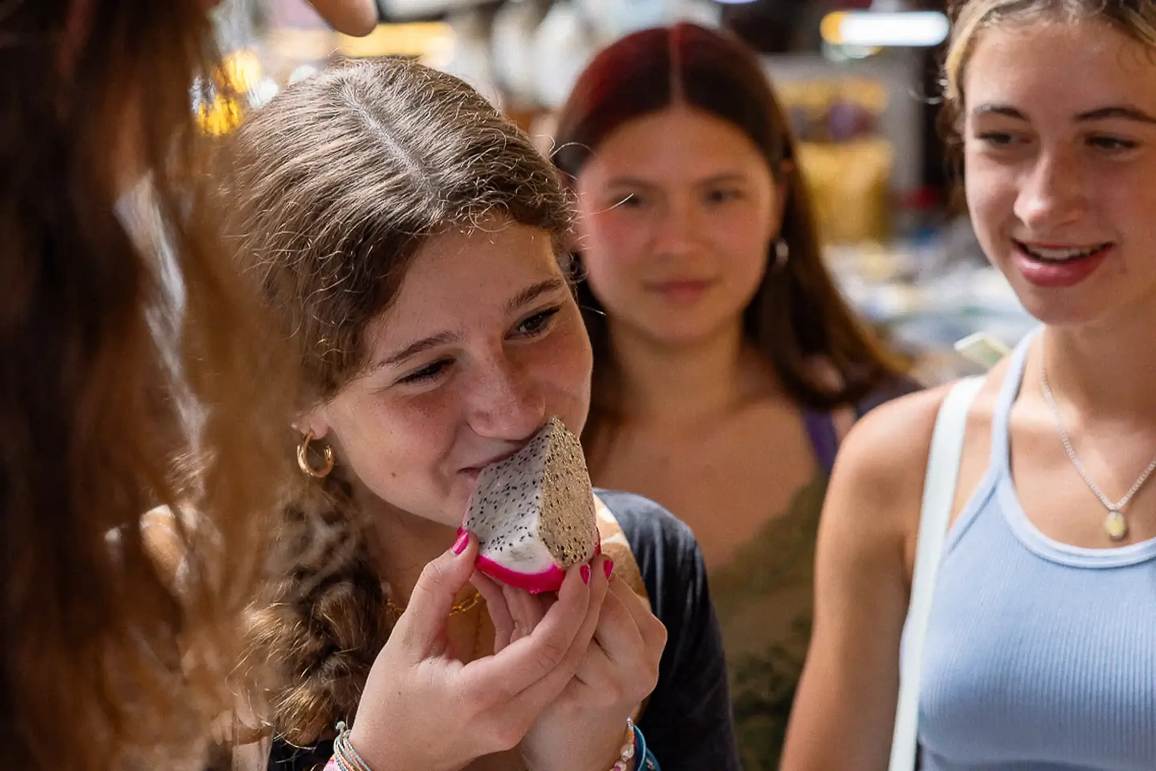 Student trying new fruit with the help of EF student payment plans