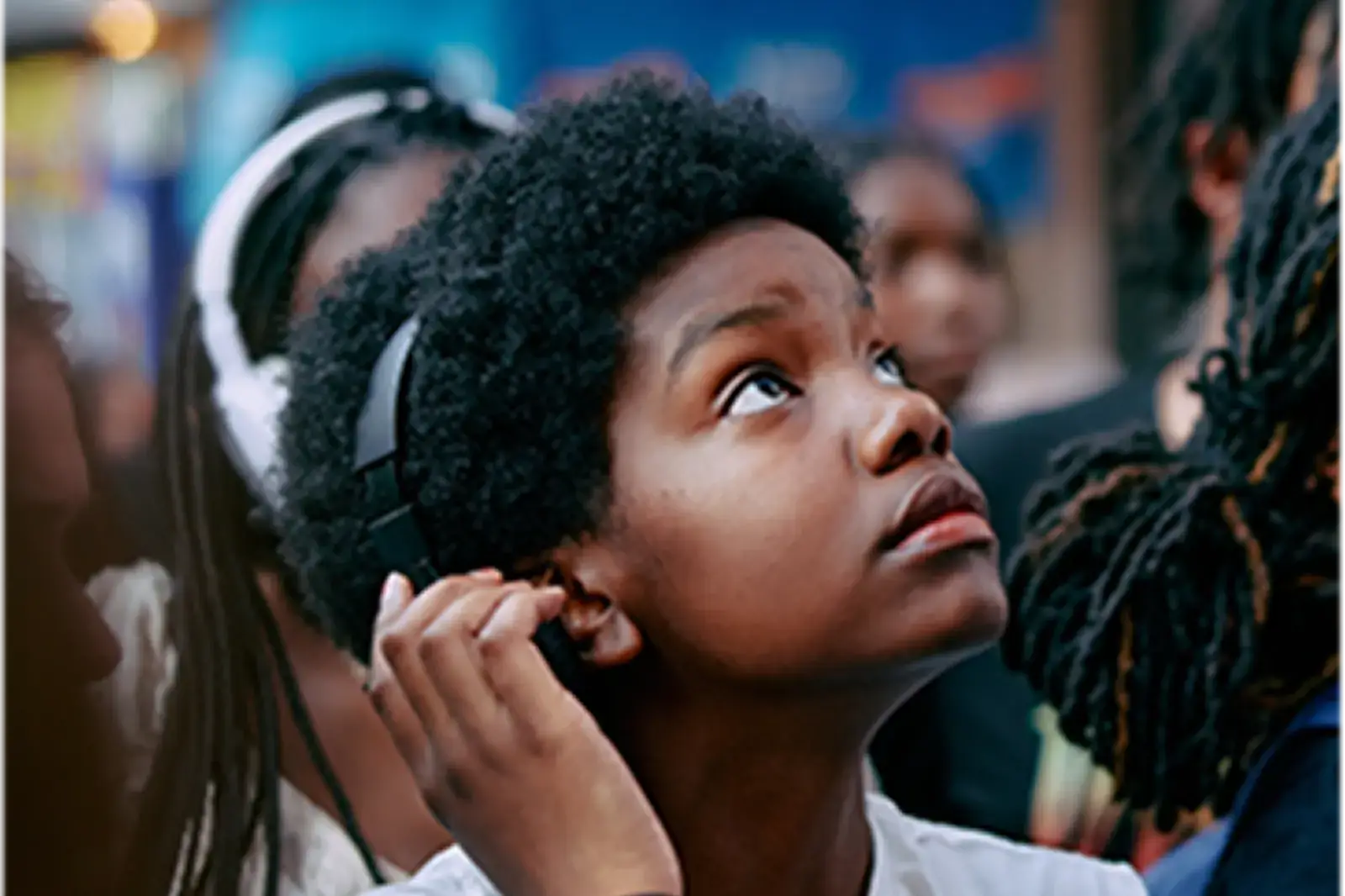 Student with headphones looking up
