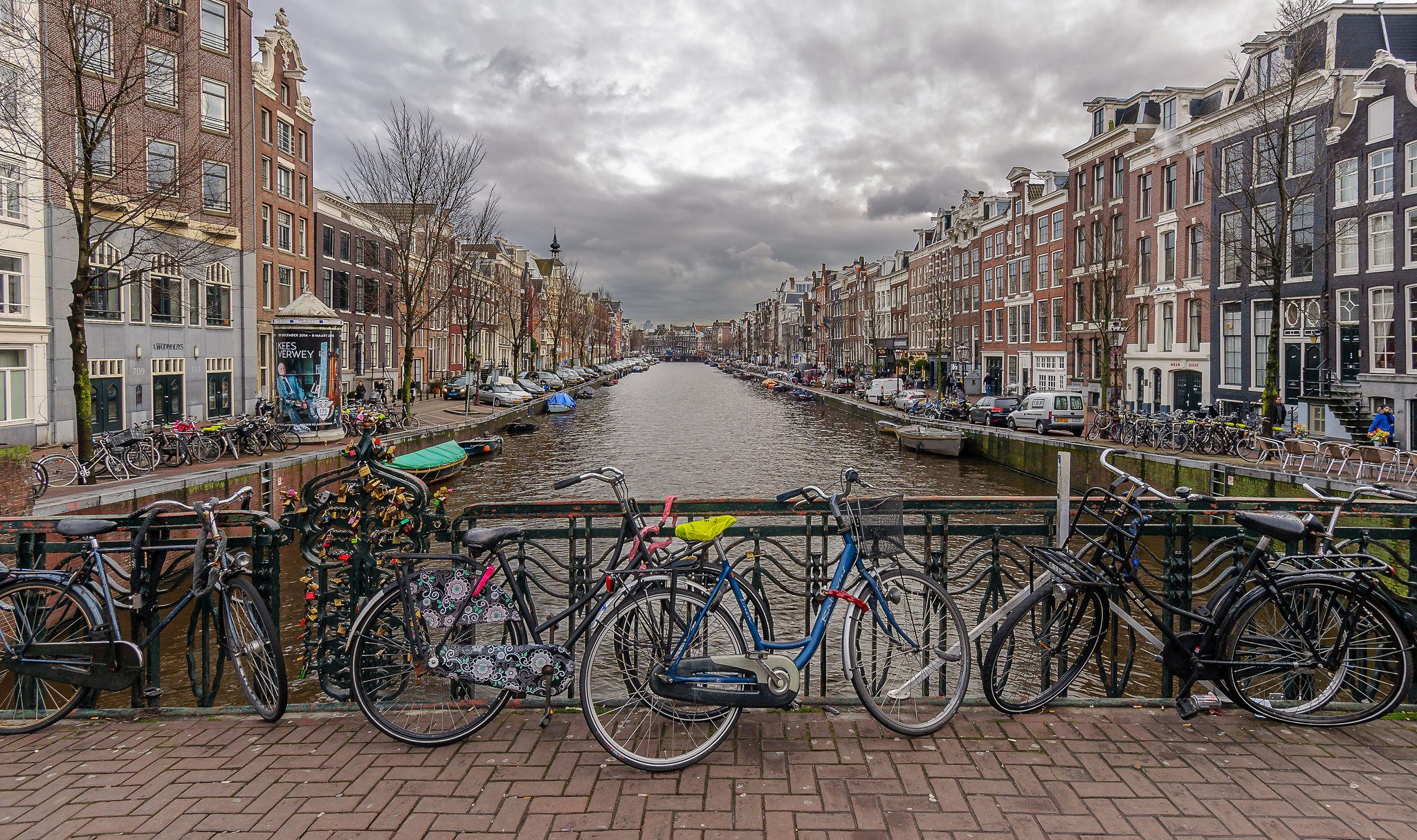 Bicycles on rail in Amsterdam near canal