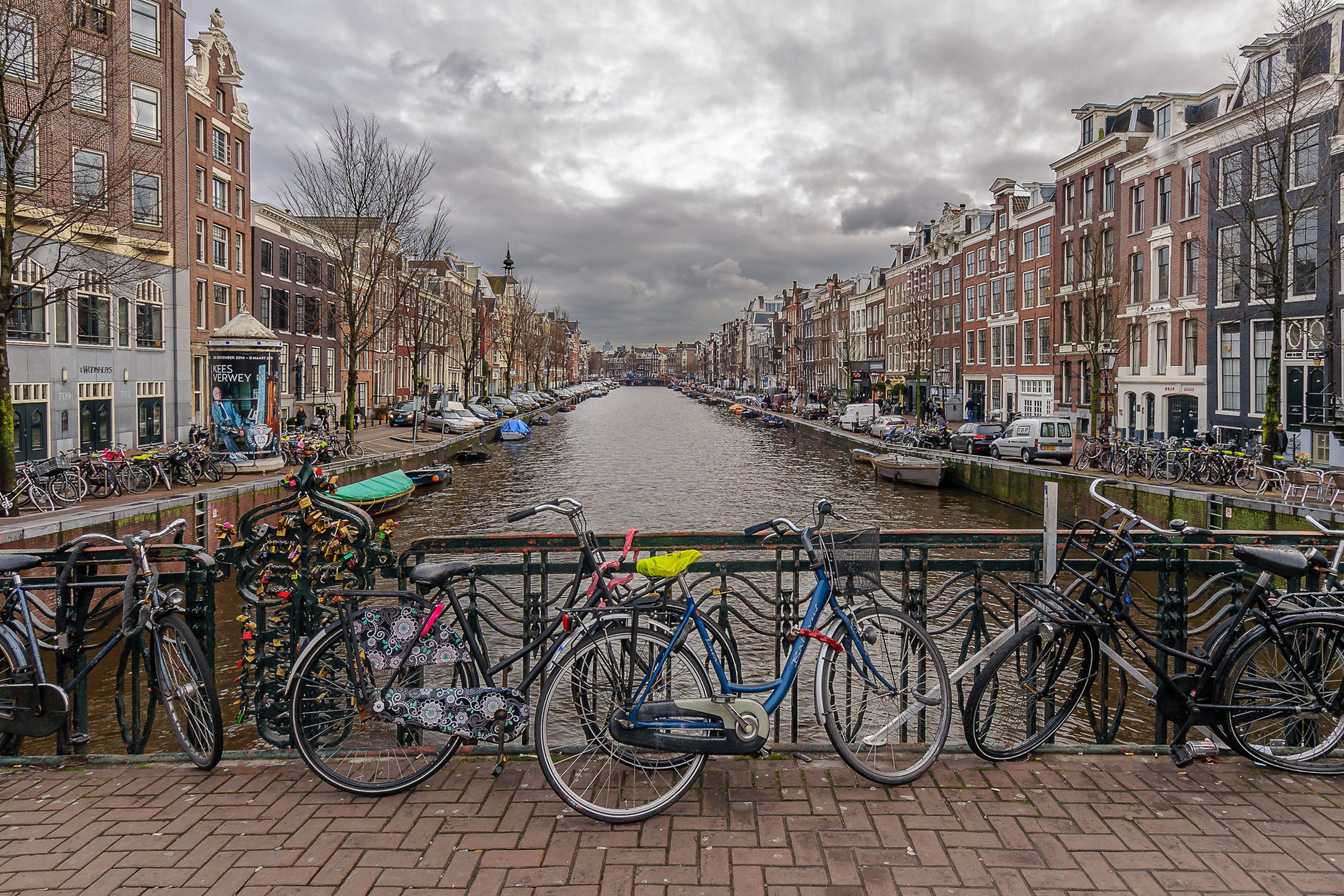 Bicycles on rail in Amsterdam near canal