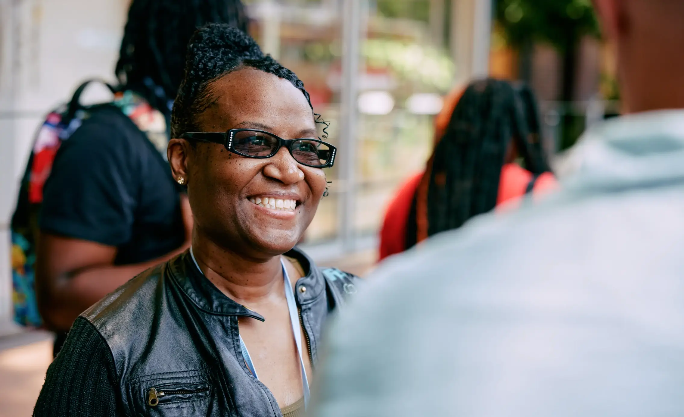 Teacher smiling and talking with an EF employee