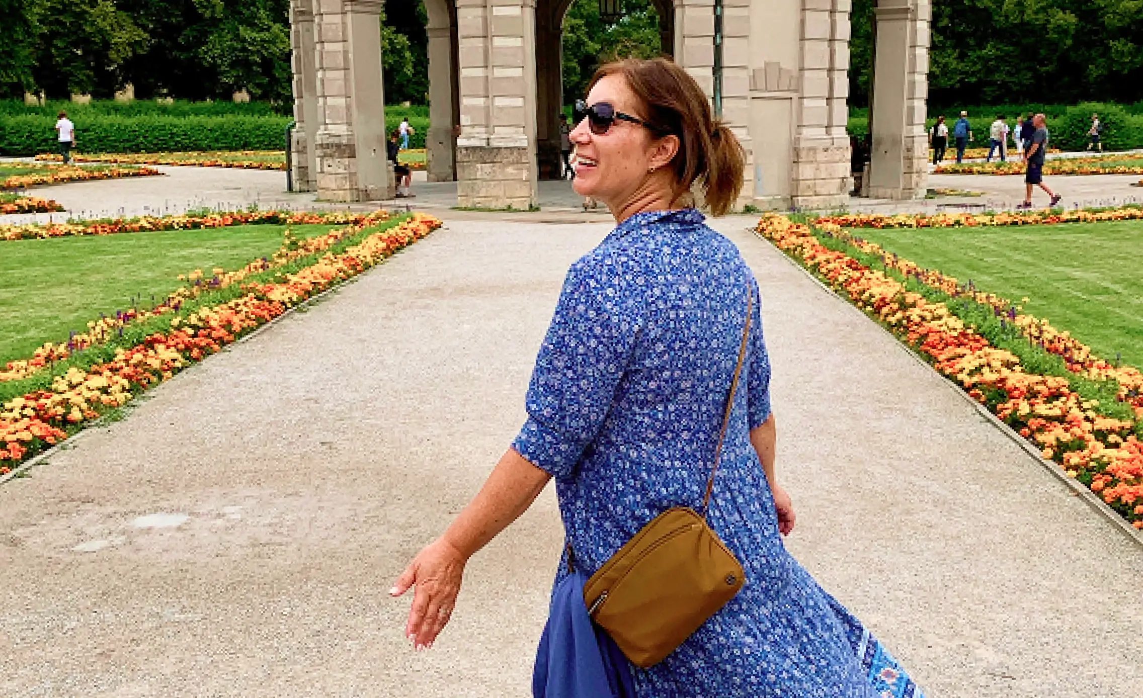 Teacher walking in a European garden