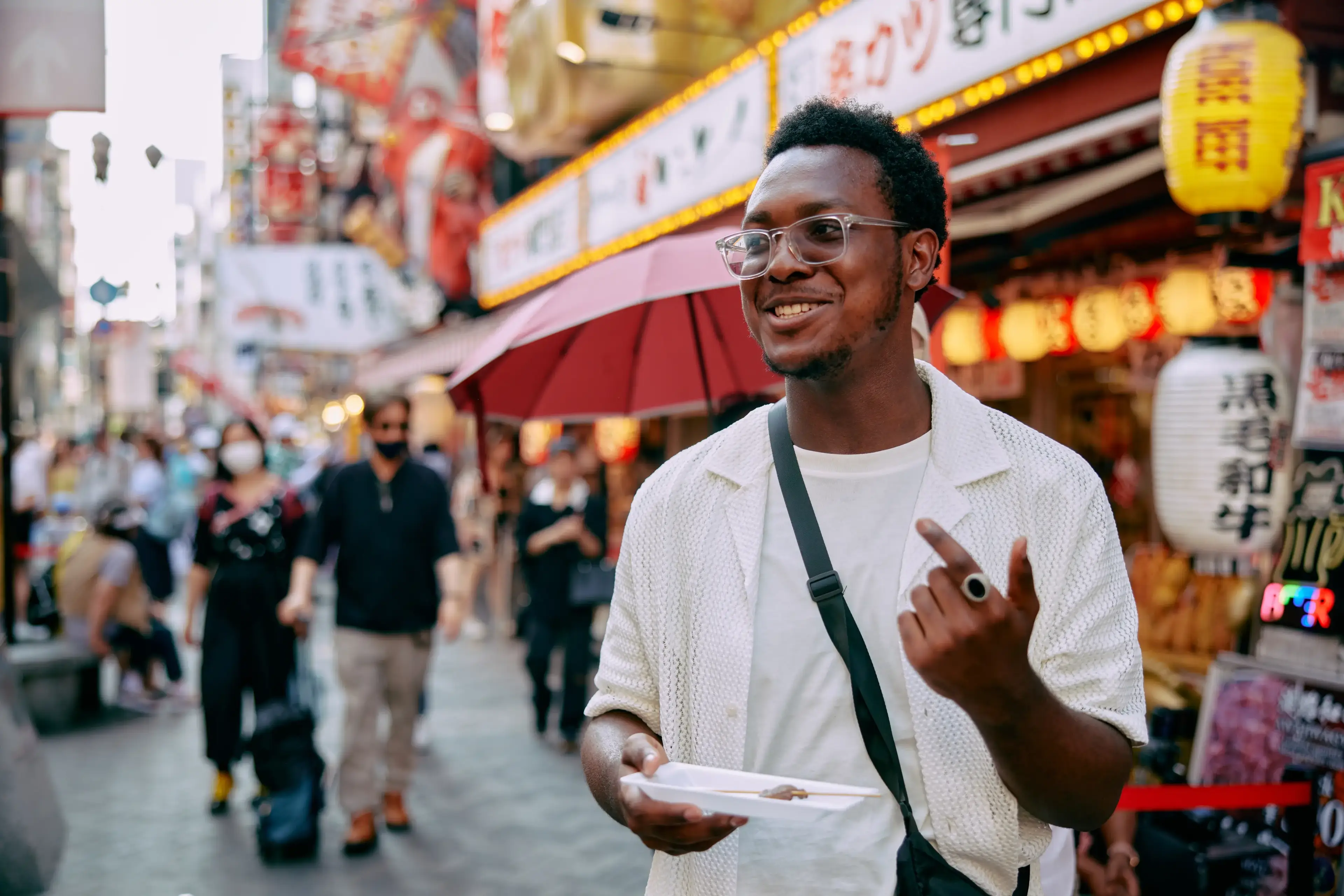 student eating street food in osaka japan
