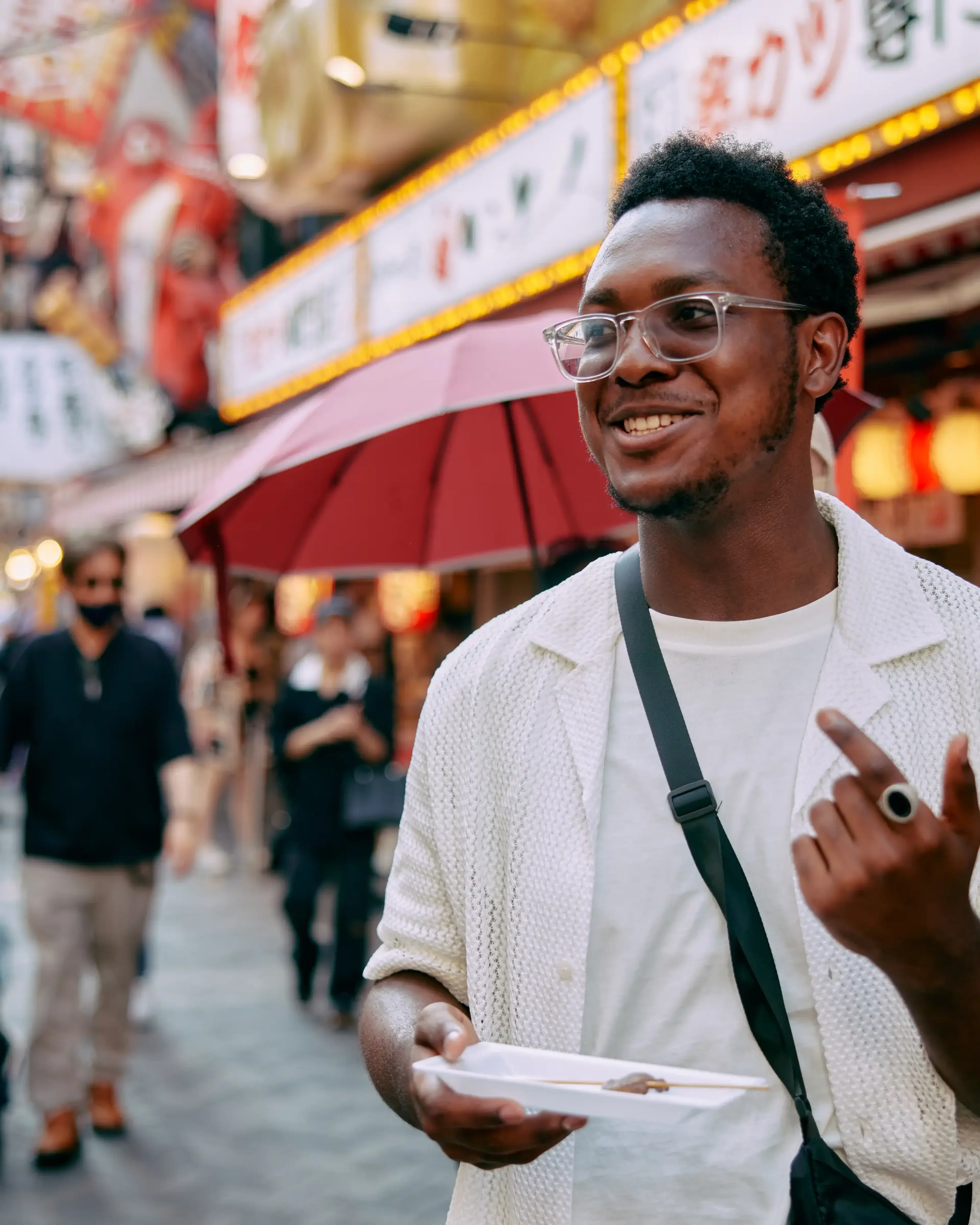 student eating street food in osaka japan