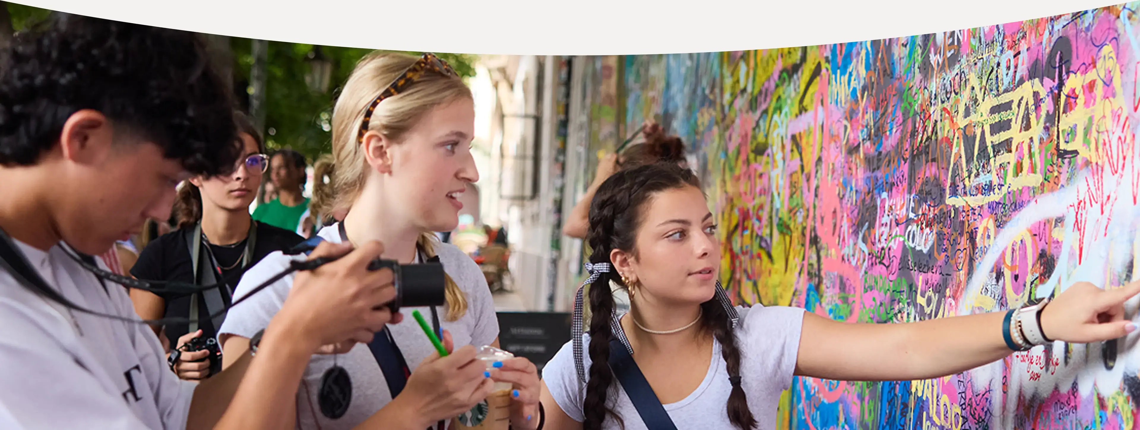 Students looking at graffiti on a wall