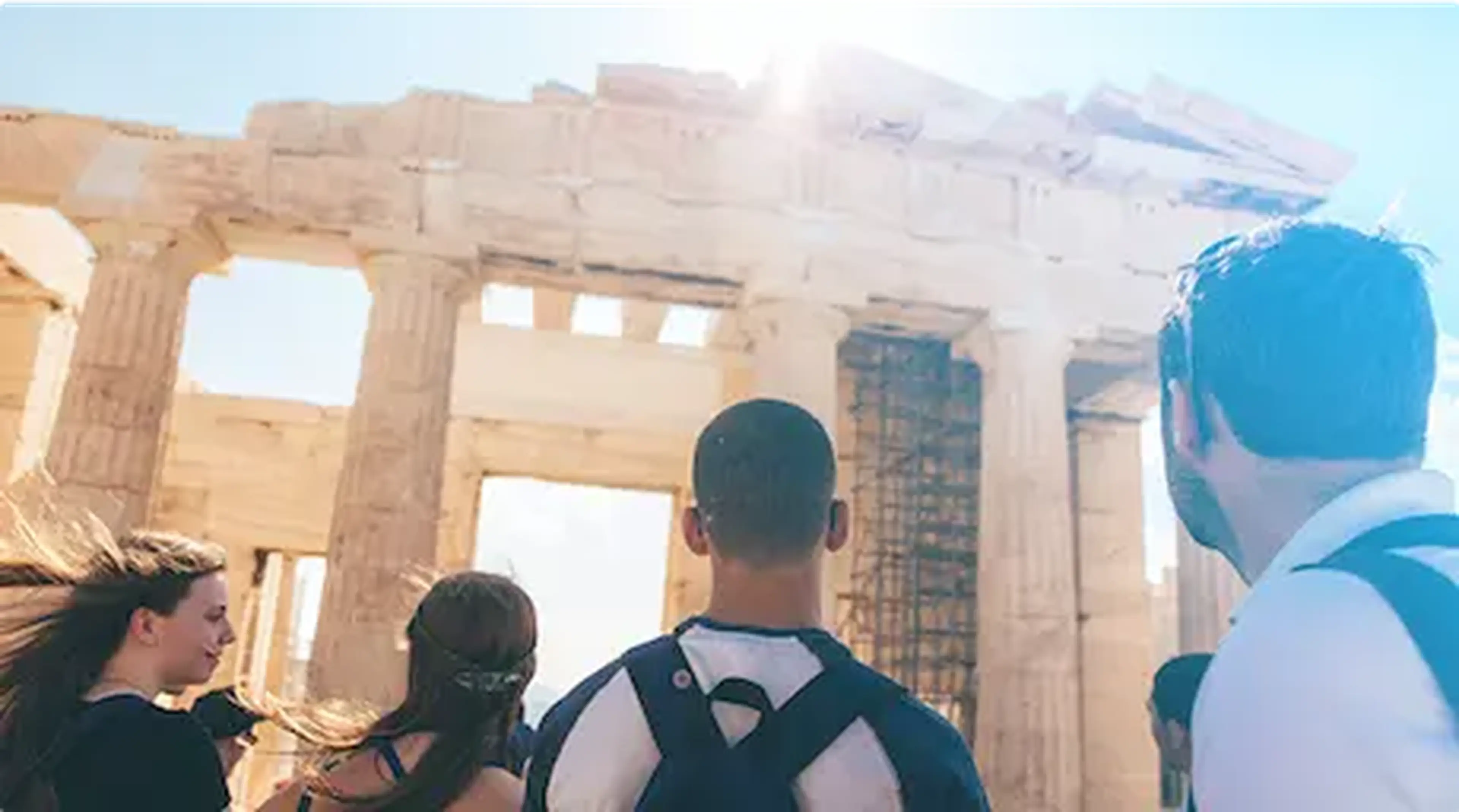 students entering ancient building ruins in greece