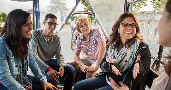 Students and teacher laughing on tour