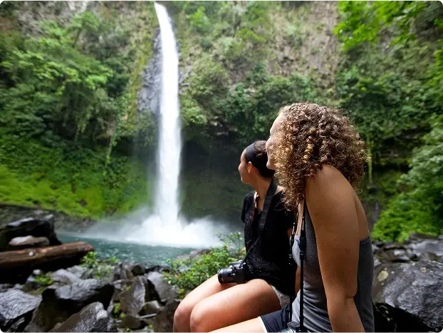 Take in La Fortuna Waterfall, cascading 230 feet from volcanic cliffs down into the jungle