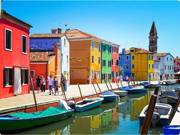 Explore the charming island of Burano, famous for its glass-blowing and vivid colors