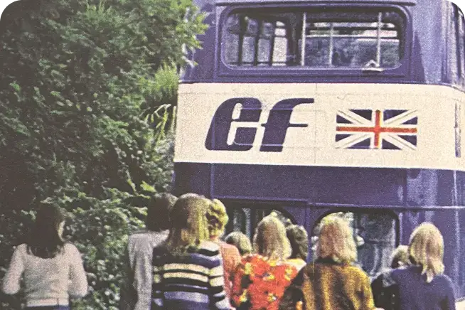 Blue vintage double decker bus in London with EF logo