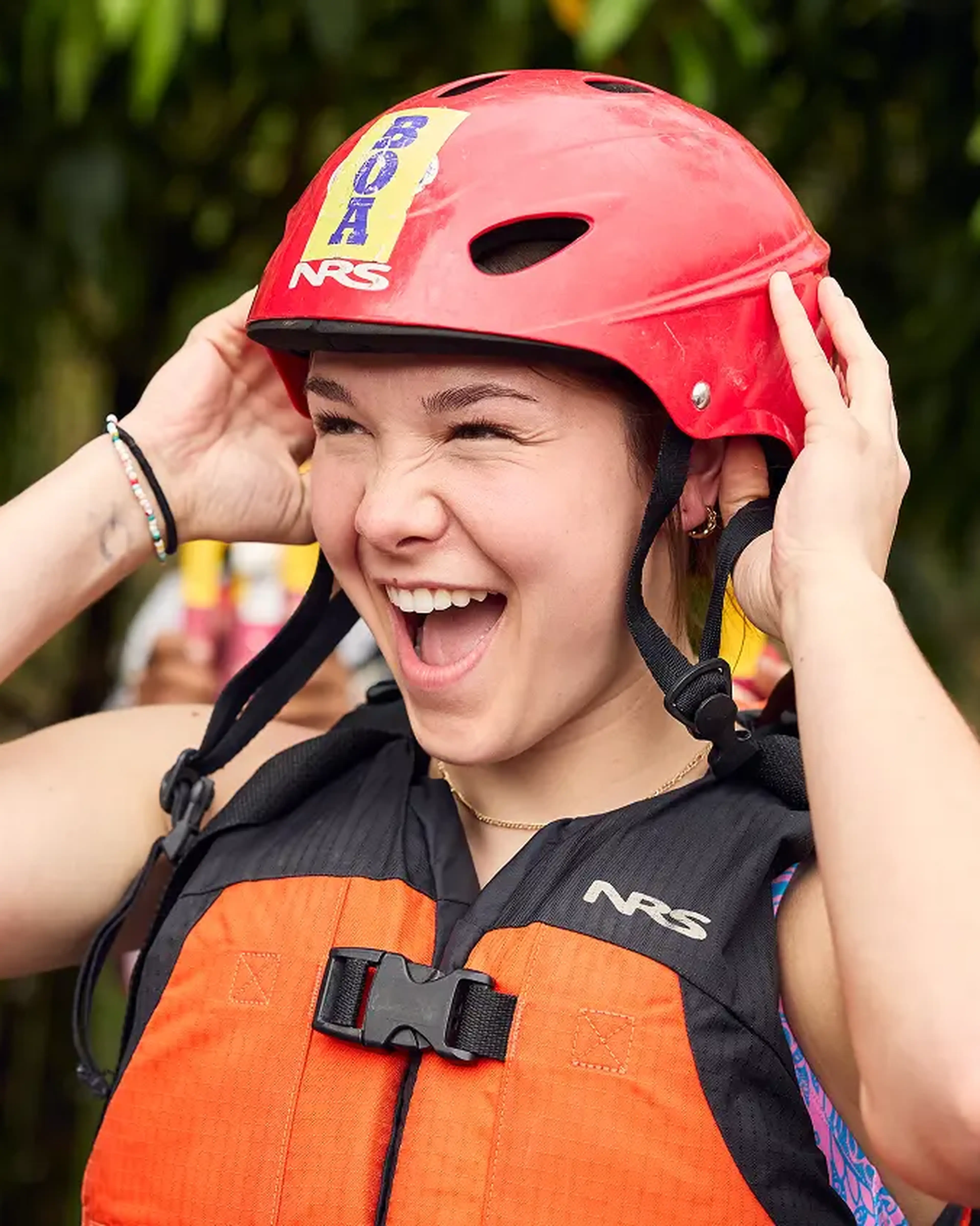 student with helmet on about to go rafting