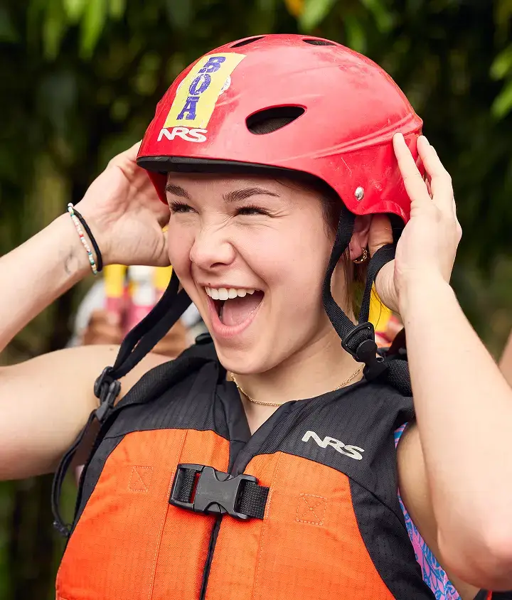 student with helmet on about to go rafting