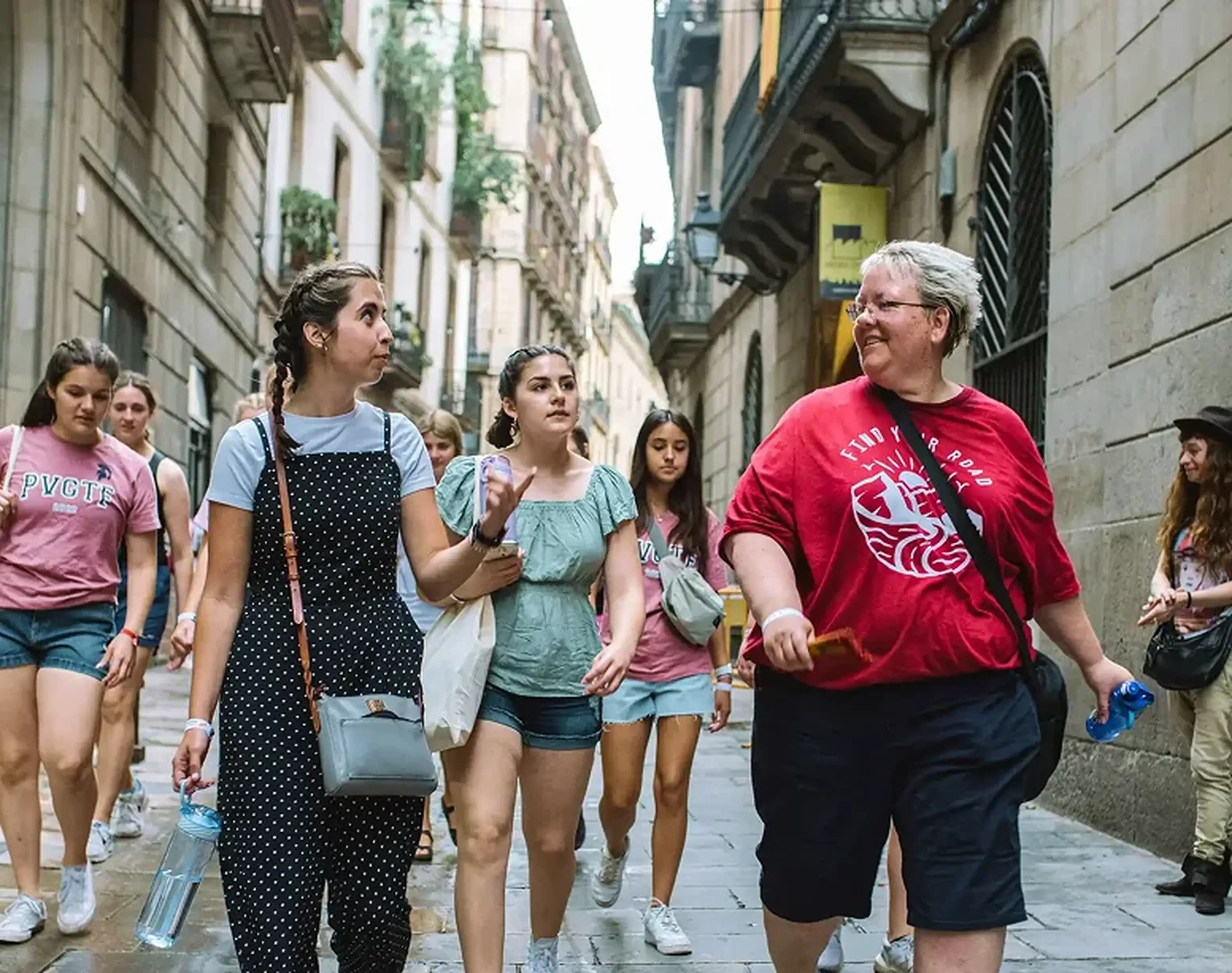 Group leader walking down a european street with students
