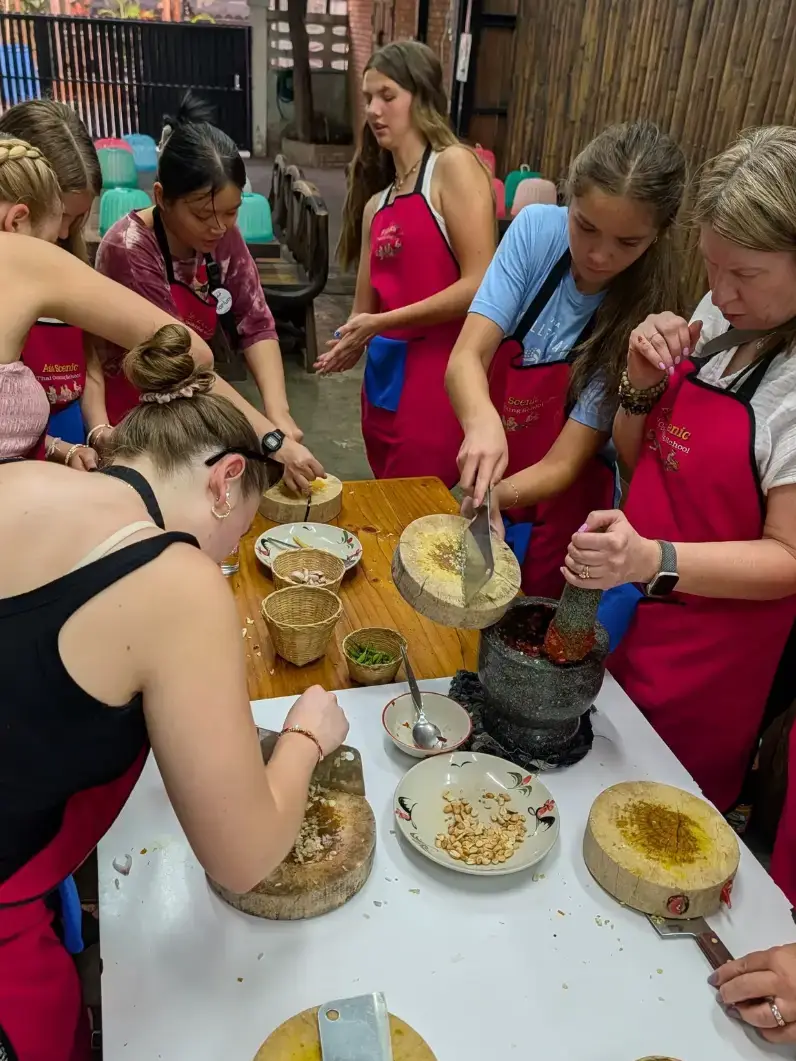 Students taking cooking class in Thailand