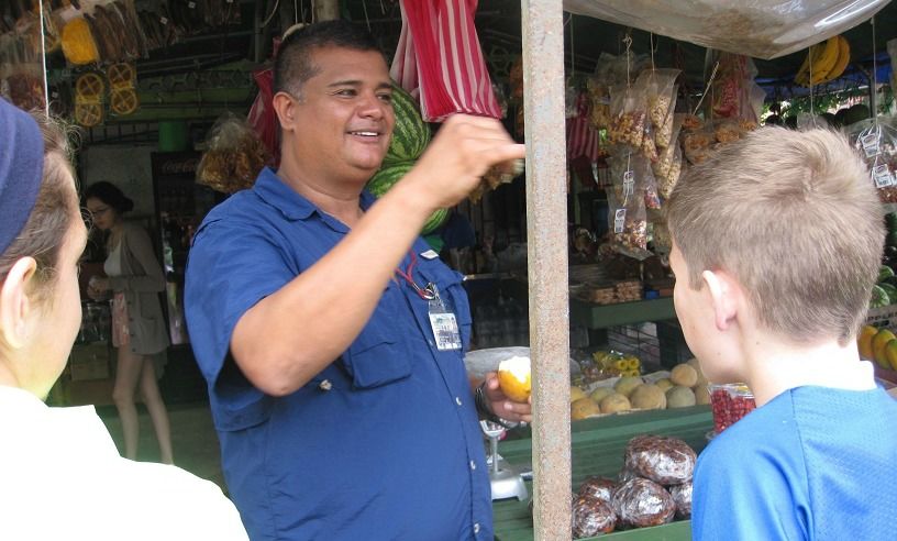 Students speaking with market vendor
