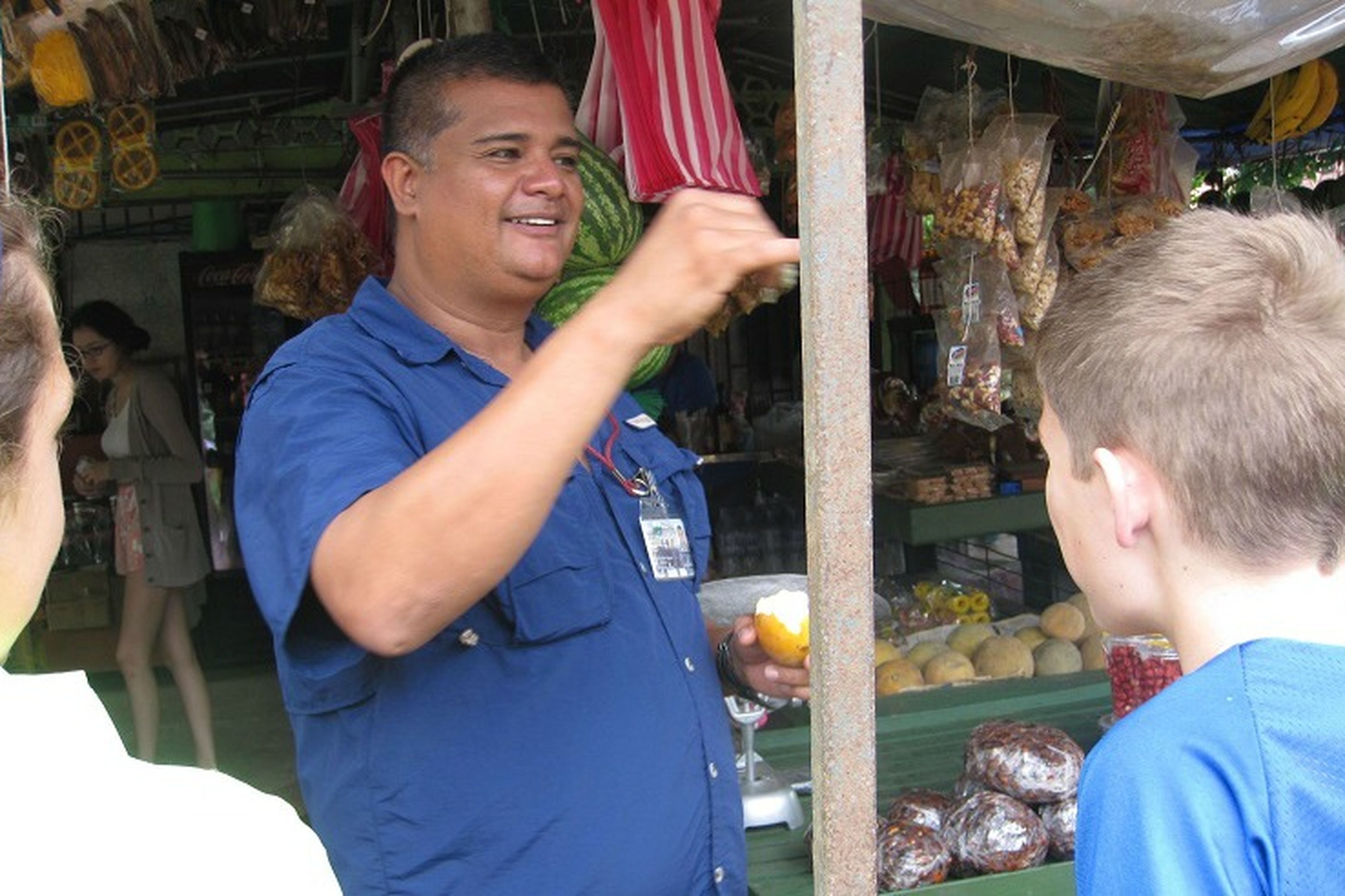 Students speaking with market vendor