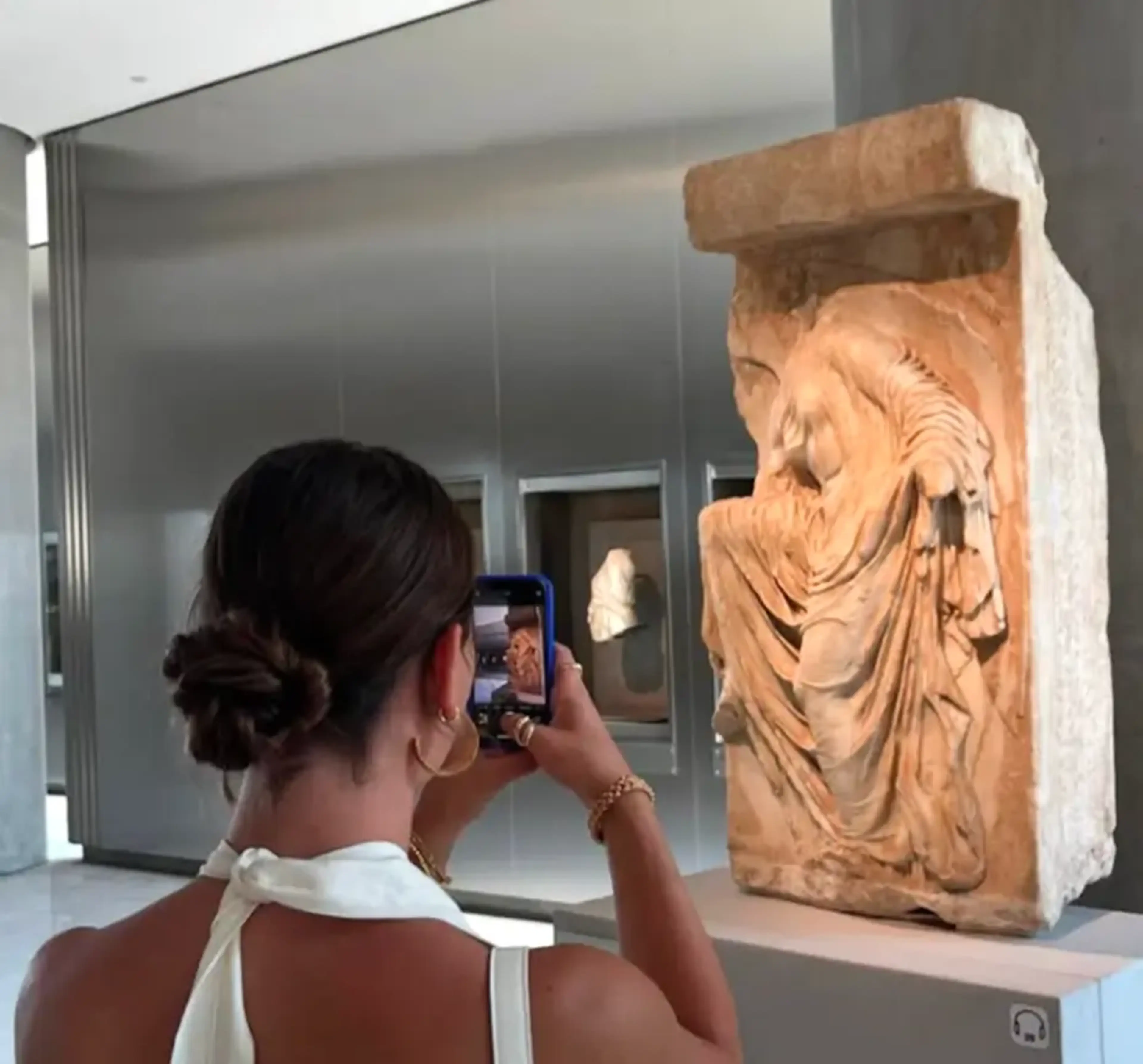 Student photographing sculpture on tour