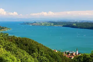 Bodensee mit Booten auf dem See und einer Stadt im Vordergrund