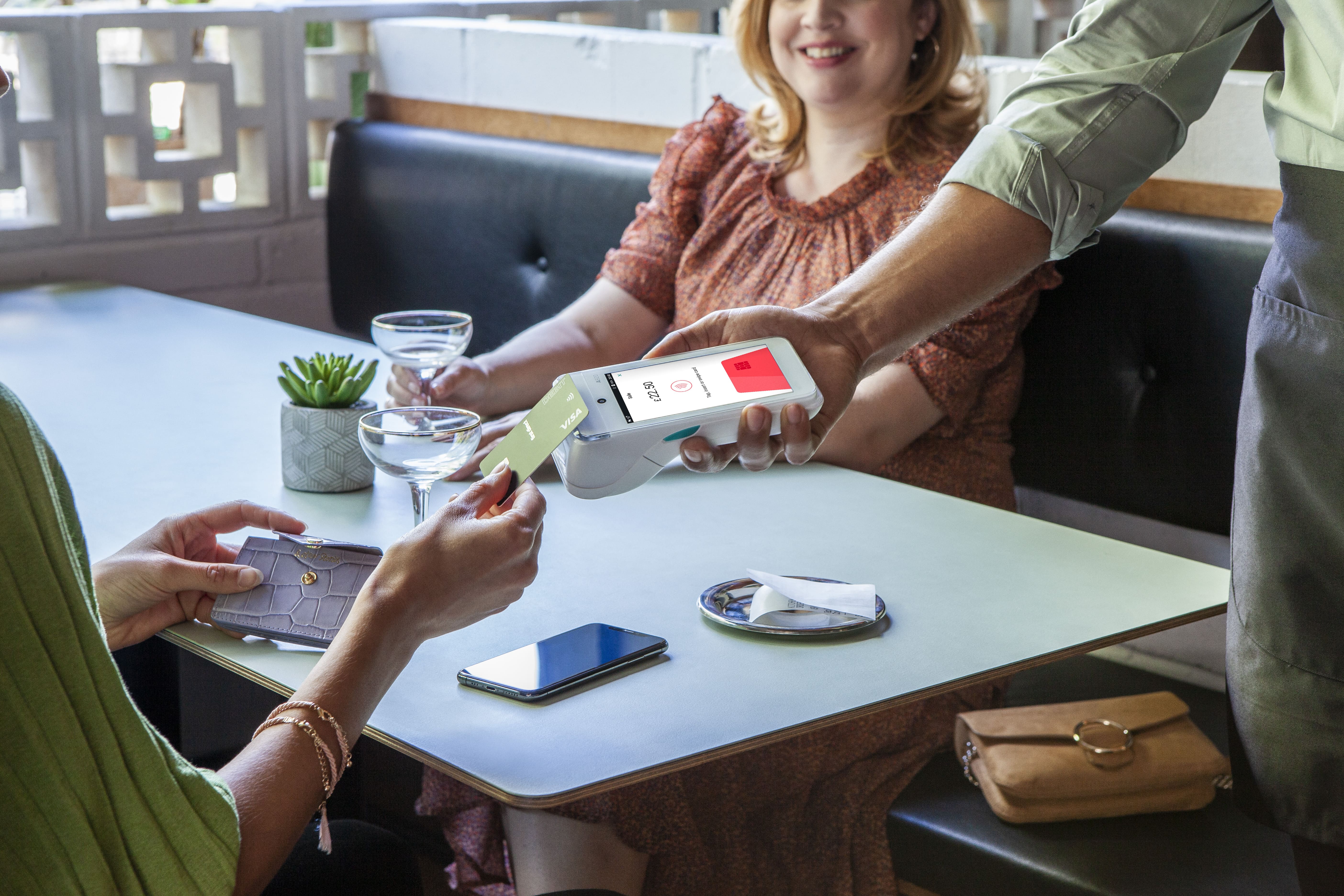 Woman paying for drink with Dojo Go