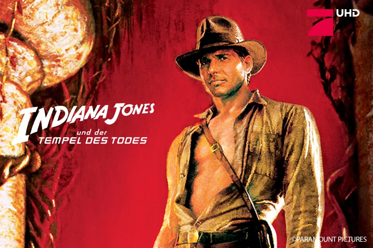 Illustriertes Poster von Indiana Jones mit Hut und Abenteueroutfit sowie dem Titel „Indiana Jones und der Tempel des Todes“ auf rotem Hintergrund.