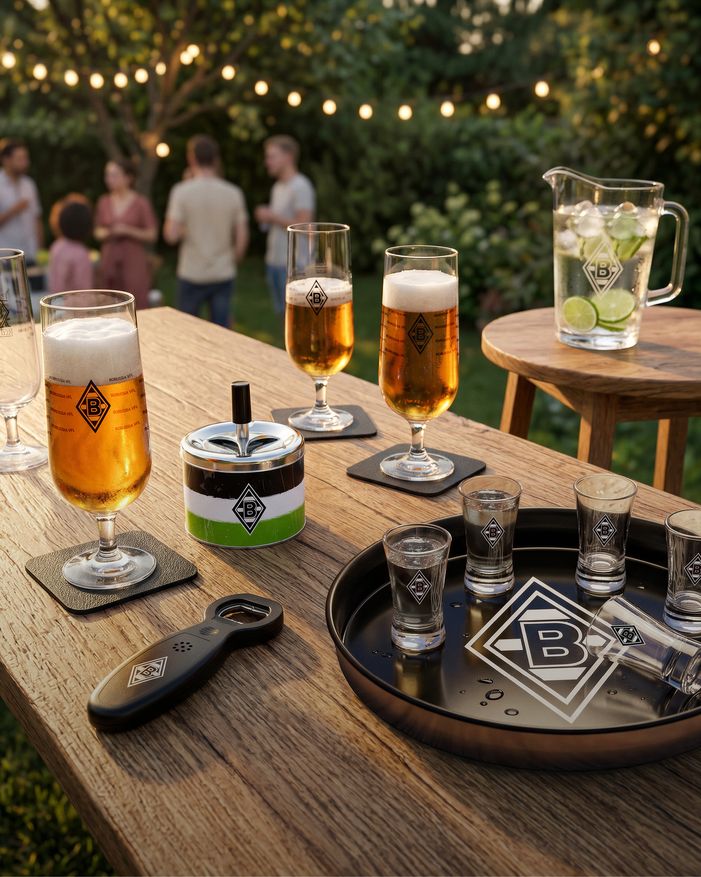 Outdoor party with glasses of beer, a pitcher with lime, shot glasses, and a bottle opener on a wooden table. People converse in the background.