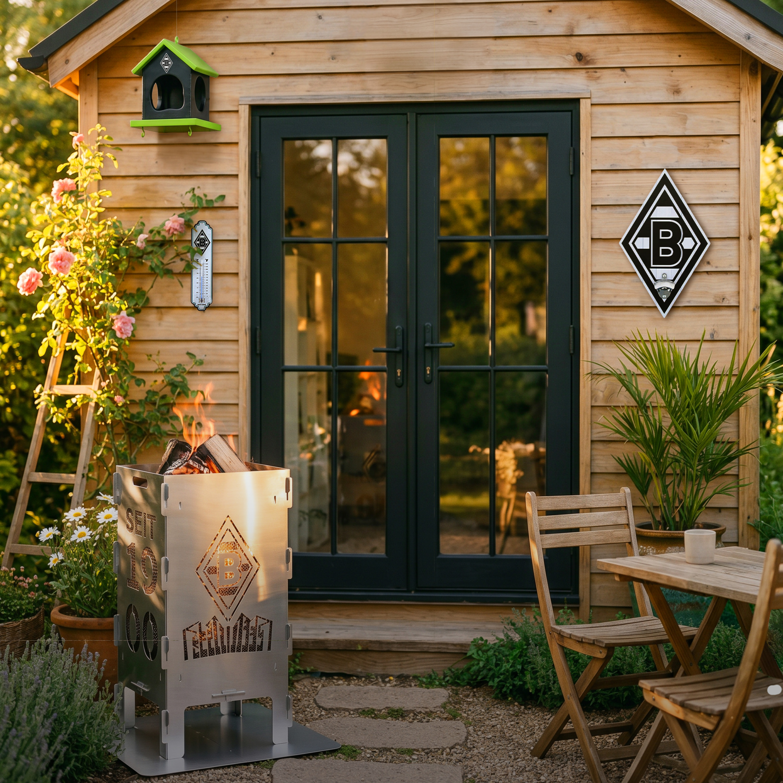 A cozy wooden cabin with black double doors, surrounded by flowers and plants. A fire pit and a small table with chairs are in the foreground.