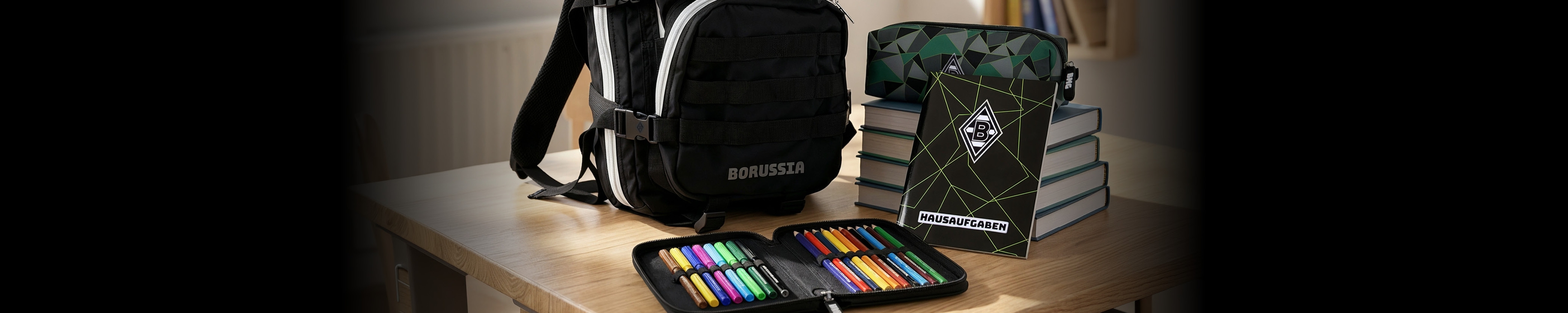 A black backpack, a pencil case with colored markers, and a stack of books with a notebook on a wooden desk.