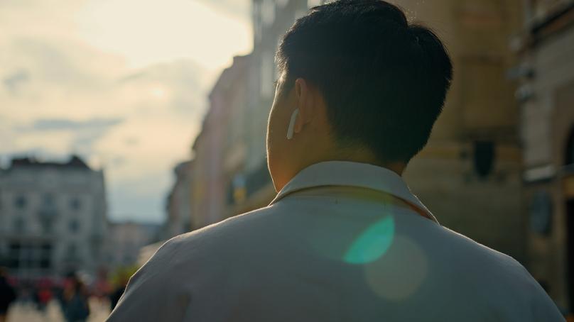 View from back unrecognizable male tourist travels new cities stands outdoors brunette man looking