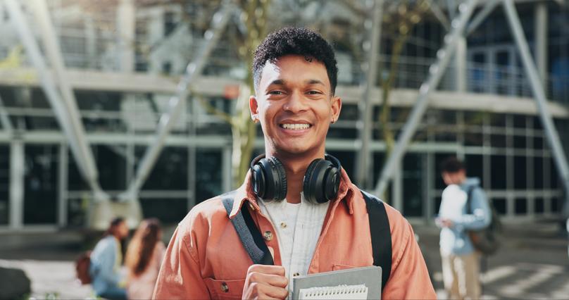 Man, outdoor and portrait of student on campus for education, learning and books for studying. Male.
