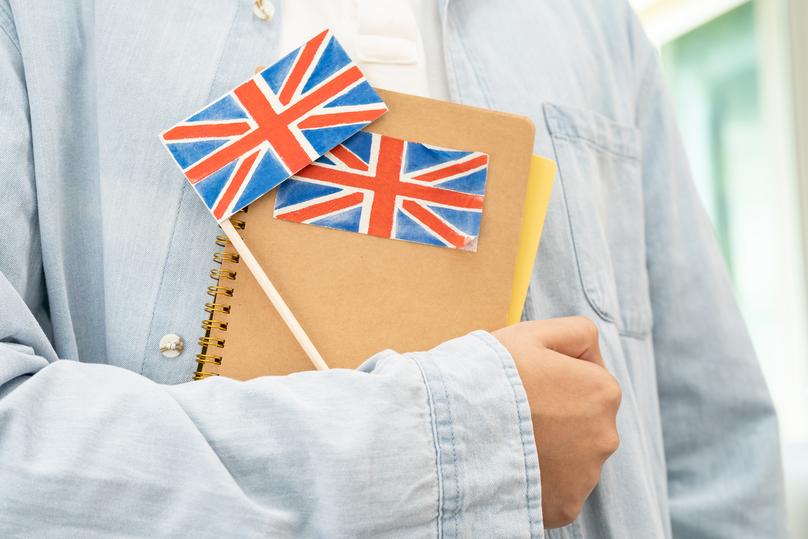 Person Holding Book with British Flag Decorations