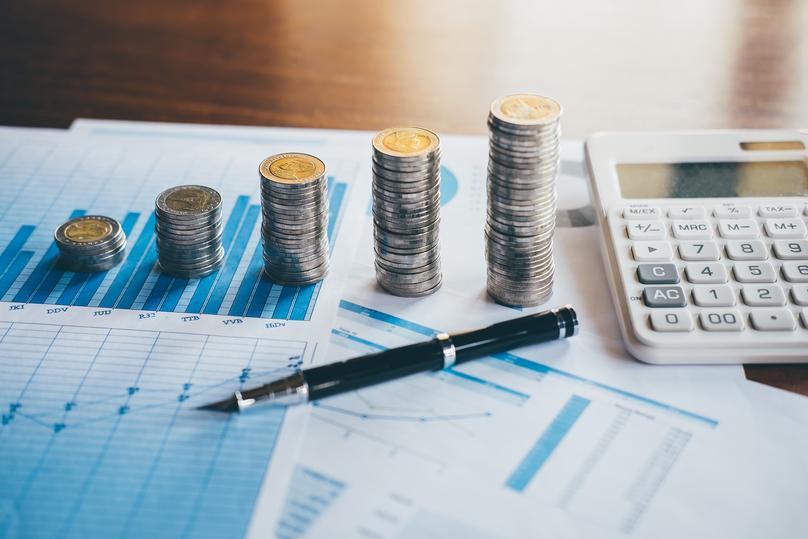 Financial Chart with Coins, Pen, and Calculator