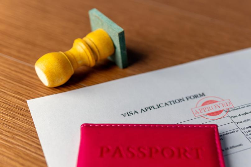 Visa application with passport and approved stamp