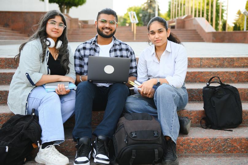Cheerful Indian asian young group of college students or friends together
