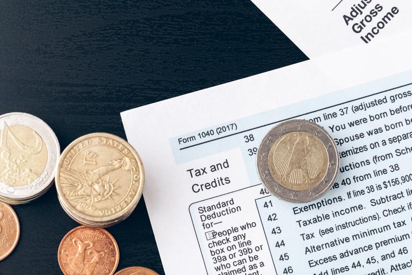 The close-up of accounting documents with money coins
