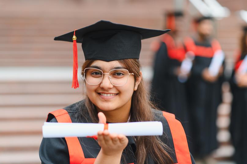 Indian woman student receiving diploma on graduation day