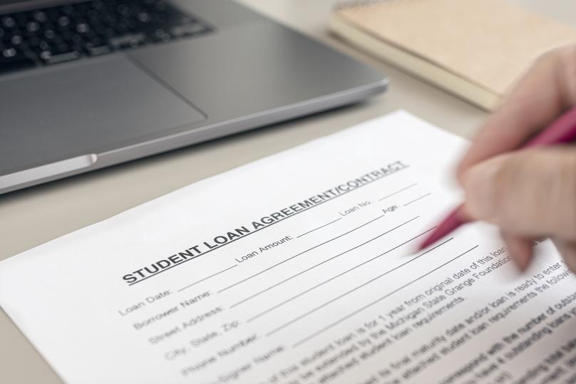 Signing a Student Loan Agreement with Laptop