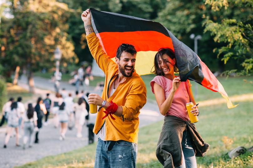 Young couple in the park with a german flag