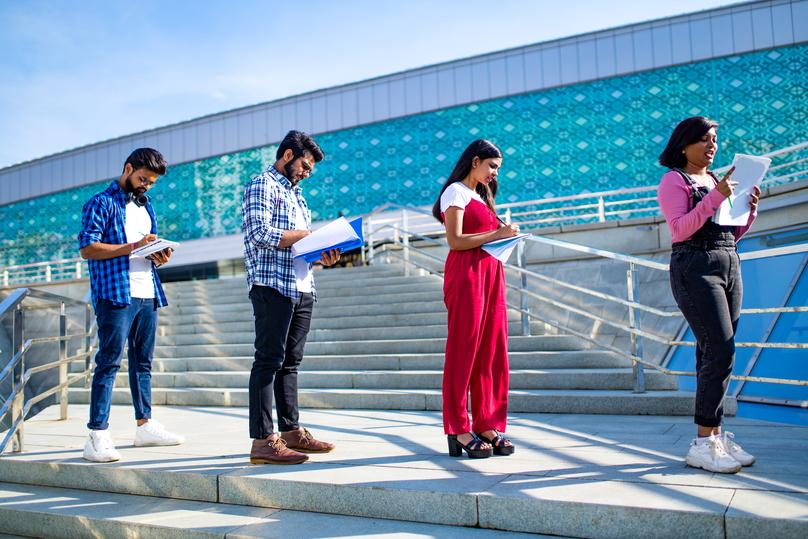 Young Adults Studying Together on Stairway