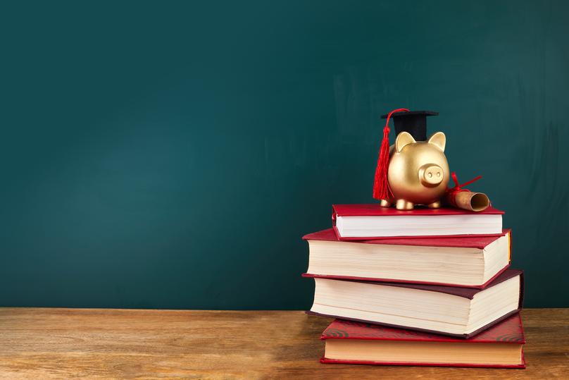 Piggy Bank Graduation on Stack of Books