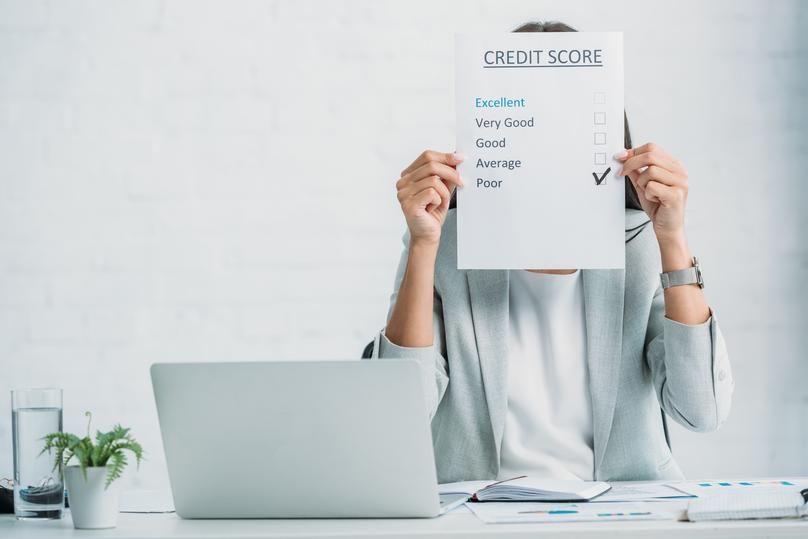 woman in formal wear showing credit score at office