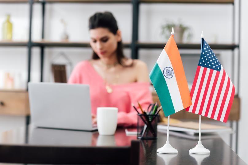 Woman Working at Home with Flags on Desk