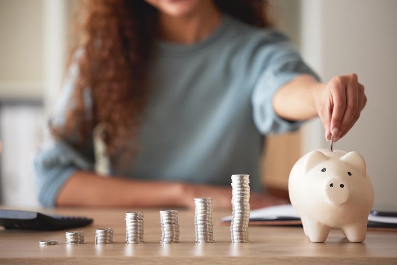 Woman Saving Money in a Piggy Bank