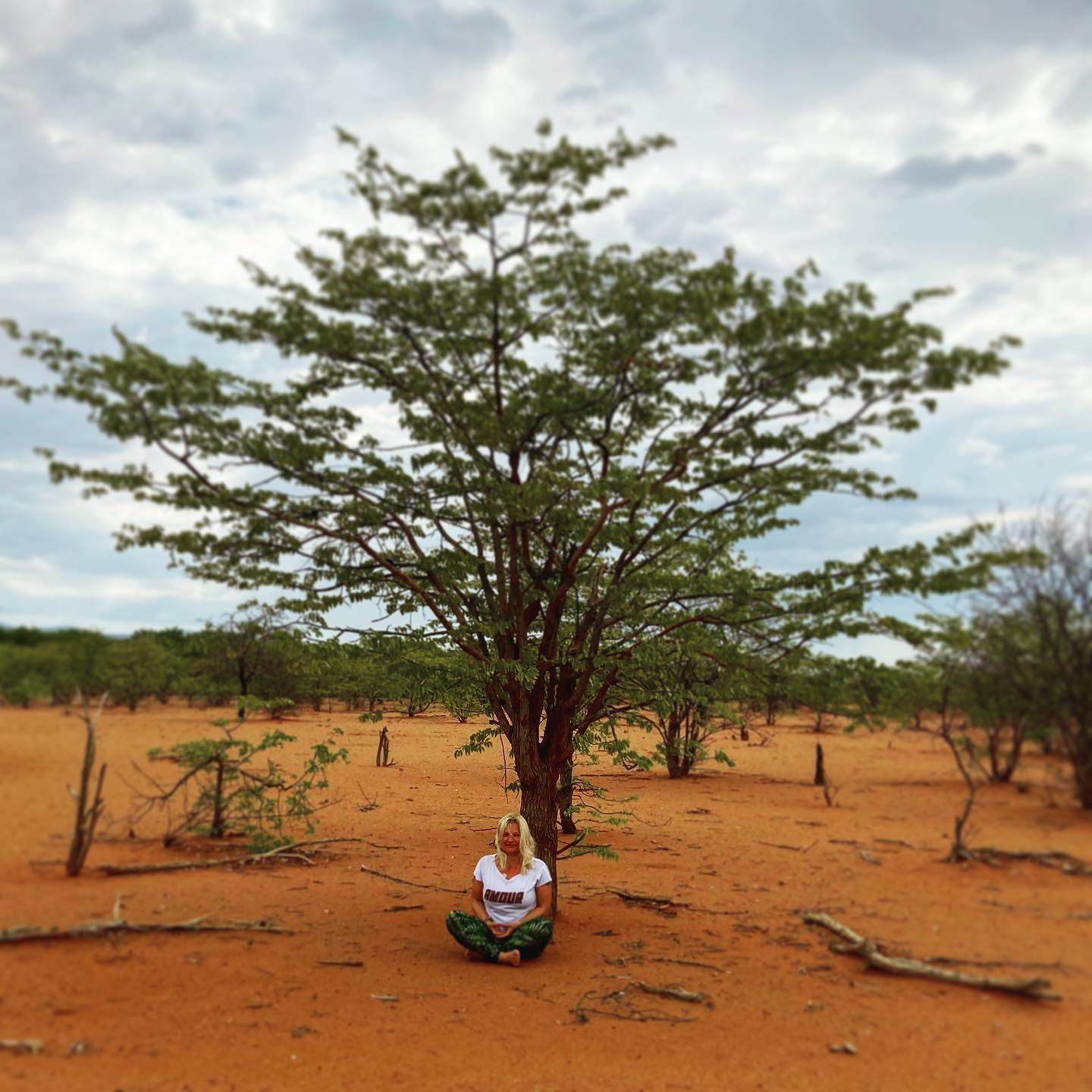 Niki contemplating against a tree